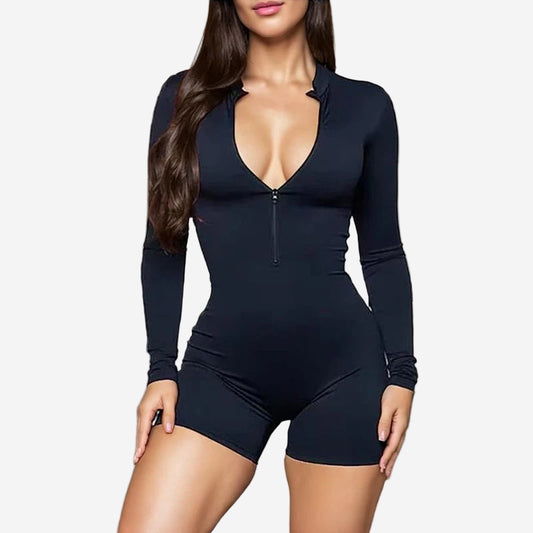 Person wearing a black bodysuit in a gym setting